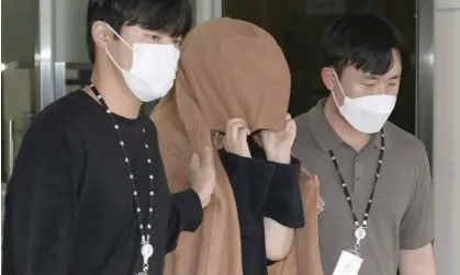  ?? Photograph: Bae Byung-soo/AP ?? The woman arrested in connection with New Zealand’s ‘suitcase murders’ leaves a Seoul police station in September.