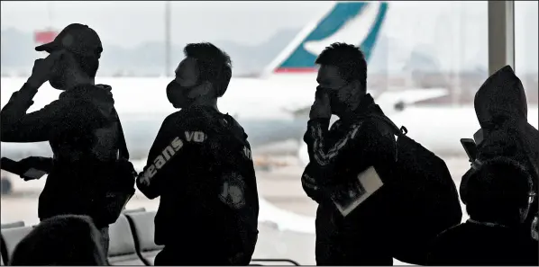  ?? ACHMAD IBRAHIM/AP ?? People line up for departure Feb. 4 at Hong Kong’s airport. The United States’ program to screen travelers ran into data problems and “bad informatio­n.”