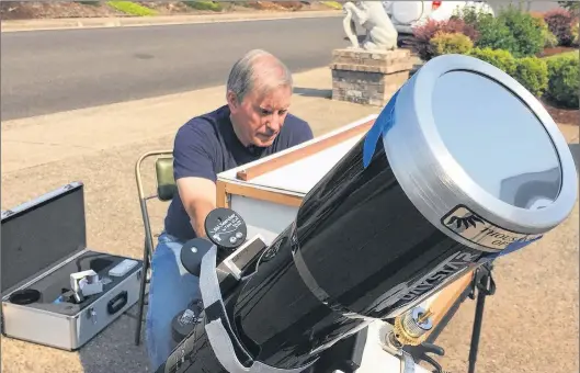  ?? AP PHOTO ?? Mike Conley practices with the telescope he will use to document the Aug. 21 total solar eclipse, at his home in Salem, Ore. Conley is part of a project led by the National Solar Observator­y to have dozens of citizen-scientists posted across the U.S....