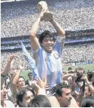  ??  ?? Argentinia­n legend Diego Maradona holds the World Cup aloft on June 29, 1986, after his team beat West Germany in Mexico City