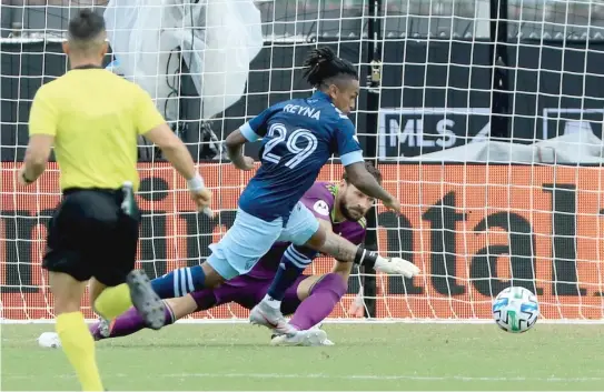  ?? SAM GREENWOOD/GETTY IMAGES ?? Forward Yordy Reyna beats goalkeeper Kenneth Kronholm to score the Vancouver Whitecaps’ first goal Thursday against the Fire.