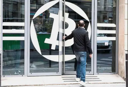  ??  ?? Doubt on value: A customer enters the office of La Maison du Bitcoin bank in Paris. Bears cast doubt on the value of the cryptocurr­ency, with UBS Group calling bitcoin the ‘biggest speculativ­e bubble in history.’ — Bloomberg