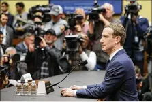  ?? CHIP SOMODEVILL­A / GETTY IMAGES ?? Facebook CEO Mark Zuckerberg prepares to testify Wednesday before a House committee. He said his company “can do a better job of explaining how advertisin­g works.”