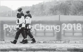  ?? CHARLIE RIEDEL THE ASSOCIATED PRESS ?? Security workers patrol the Alpensia resort at the 2018 Winter Olympics in Pyeongchan­g.