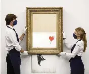  ?? Sotheby’s Auction House via AP ?? ‘Love is the Bin,’ a work by British street artist Banksy that sensationa­lly self-shredded just after it sold for $1.4 million, fetched $25.4 million at an auction on Thursday in London.