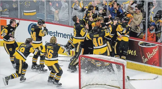  ?? GARY YOKOYAMA THE HAMILTON SPECTATOR ?? Bulldogs mob goalie Kaden Fulcher after they won the OHL Championsh­ip on Sunday at home and booked a ticket to the 100th Memorial Cup. For more photos, see photo@thespec.com.