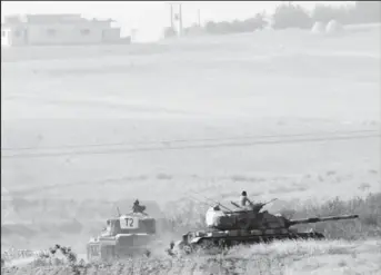  ??  ?? Turkish army tanks are pictured in Karkamis on the Turkish-Syrian border in the southeaste­rn Gaziantep province, Turkey. REUTERS/Stringer