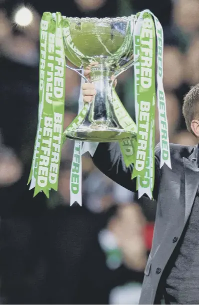  ??  ?? 0 Celtic manager Brendan Rodgers celebrates with the supporters at Hampden Park on Sunday after his side lifted their fourth piece of silverware in a row, a feat not achieved since Jock Stein was in charge.