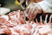  ?? GERALD HERBERT/AP ?? A wild boar gets butchered at the Springfiel­d Slaughter House in Springfiel­d, La. It’s the company’s main business.