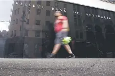  ??  ?? A worker walks past the Reserve Bank of Australia (RBA) head office in central Sydney, Australia. Australia’s central bank kept its cash rate steady at a record low of 2.0 per cent on Tuesday, a widely expected decision given signs the domestic economy...