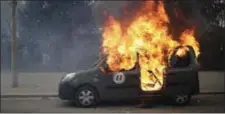  ??  ?? A burning command car belonging to France’s anti-terrorist squad goes up in smoke after being torched by anti-government demonstrat­ors.