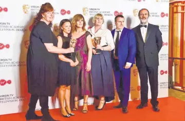  ??  ?? Cast of ‘Happy Valley’ - which was named best drama - pose with their trophies. • (Below) Sarah Lancashire of ‘Happy Valley’ wins the Best actress title.