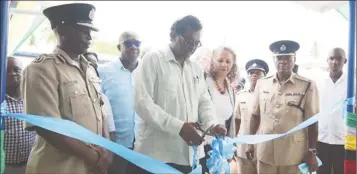  ??  ?? Minister of Public Security Khemraj Ramjattan, flanked by Country Manager of the IDB Sophie Makonnen and senior officials of the Guyana Police Force (GPF) and ranks of ‘E’ Division, cuts the ribbon to officially commission the Mackenzie Police Station.
