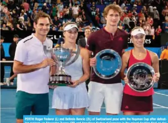  ??  ?? PERTH: Roger Federer (L) and Belinda Bencic (2L) of Switzerlan­d pose with the Hopman Cup after defeating runners-up Alexander Zverev (2R) and Angelique Kerber of Germany in the mixed doubles final on day eight of the Hopman Cup tennis tournament in...