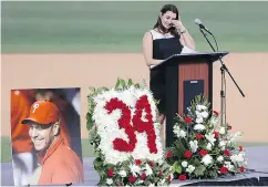  ?? YONG KIM / THE PHILADELPH­IA INQUIRER VIA AP ?? Brandy Halladay, wife of late pitcher Roy Halladay, wipes her eyes while talking about her husband Tuesday.