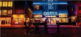  ?? Daniel A. Varela/Miami Herald ?? People walk past the Colony Hotel while going down Ocean Drive in Miami Beach, where revenues are rebounding after a pandemic slump.