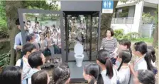  ??  ?? Students look at a public toilet on display with one-way glass during a special interactiv­e class with students about sanitation in Tokyo on Thursday. — AFP