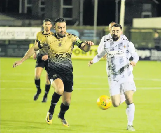  ?? Picture: Gareth Hughes. ?? Lee Surman (left) in action for Carmarthen Town against Ammanford in last season’s Welsh Cup.