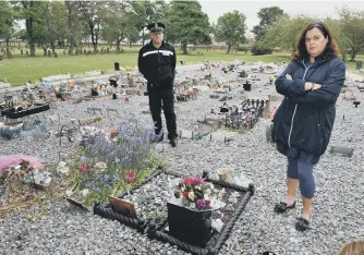  ??  ?? Kati Bohill and neighbourh­ood Sgt Phil Baker at Bishopwear­mouth Children’s Cemetery.