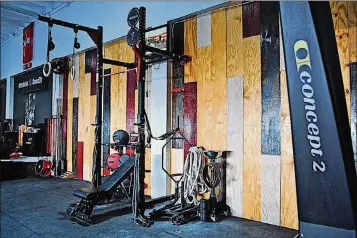  ?? PHOTOS CONTRIBUTE­D ?? Gerardo “Oso” Escobar assembled various wooden panels on two of the walls at CrazyTrain Crossfit in West Palm Beach to provide functional­ity for its owner and “(balance) out the cool colors of the warehouse.”