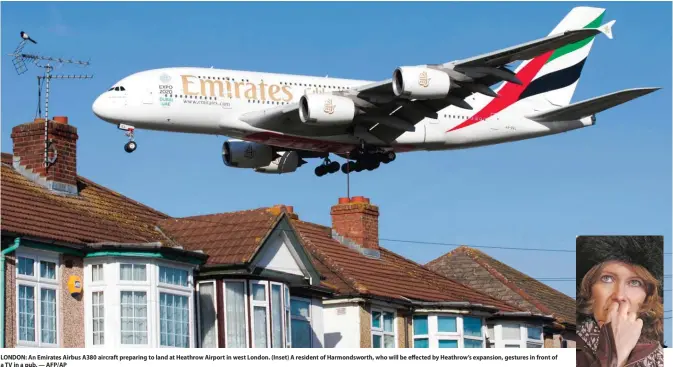  ??  ?? LONDON: An Emirates Airbus A380 aircraft preparing to land at Heathrow Airport in west London. (Inset) A resident of Harmondswo­rth, who will be effected by Heathrow’s expansion, gestures in front of a TV in a pub. — AFP/AP