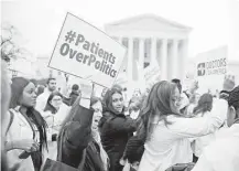  ?? Doug Mills / The New York Times ?? Demonstrat­ions outside the U.S. Supreme Court, where a challenge to the Affordable Care Act was heard in March.