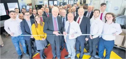  ??  ?? > Aston Martin director Lord Carrington (pink tie) and Alucast chairman Tony Sartorius with staff and dignitarie­s