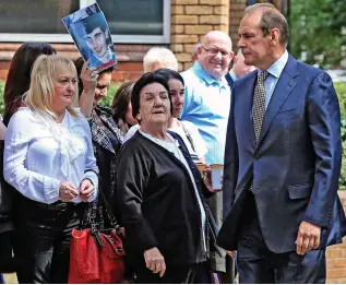  ??  ?? Mother: Jenny Hicks, in a white blouse, locks eyes with Norman Bettison yesterday