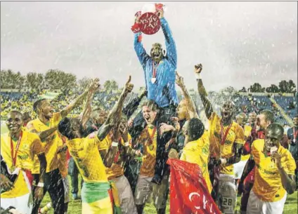  ??  ?? A history of winning: Mamelodi Sundowns coach Pitso Mosimane and the players celebrate winning the league in 2014. Photo: Steve Haag/Gallo Images