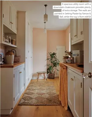  ?? ?? A spacious utility room with a downstairs cloakroom provides plenty of extra storage. The walls are painted in Setting Plaster by Farrow & Ball, while the rug is from edit58