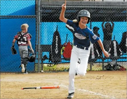  ?? PHOTOS BY STAN HUDY — SHUDY@DIGITALFIR­STMEDIA.COM ?? Saratoga Springs Little League batter Holden Johnson is all smiles after his walk-off base on balls Monday night against Mechanicvi­lleStillwa­ter in the opening round of the 11-12-year-old District 11 and 12 playoffs.