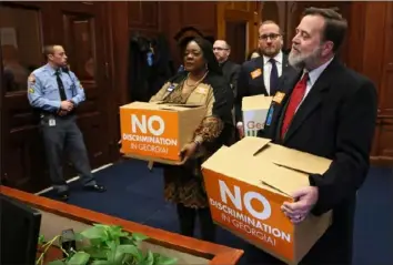  ?? Bob Anders/Atlanta Journal-Constituti­on ?? Jeff Graham, right, executive director of Georgia Equality, leads supporters as they deliver copies of 75,000 emails to lawmakers and to the governor's office in March 2016 in Atlanta.