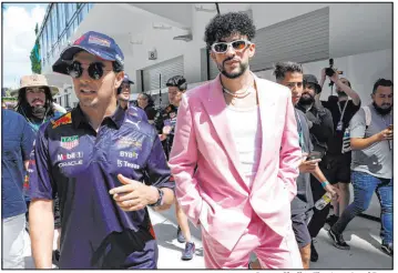  ?? Lynne Sladky The Associated Press ?? Celebritie­s were all over Miami’s Hard Rock Stadium on Sunday, including musician Bad Bunny, right, who walked in with driver Sergio Perez.