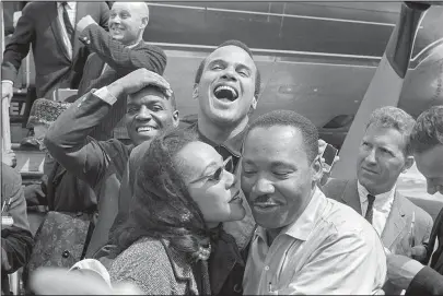  ?? The Associated Press ?? KING: Dr. Martin Luther King Jr., right, receives a kiss from his wife Coretta Scott King in 1963 as they appear in Alabama with Nipsey Russell, back row left, and Harry Belafonte. The image appears in the documentar­y "King in the Wilderness."