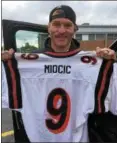  ?? MARK PODOLSKI — THE NEWS-HERALD ?? Stipe Miocic shows off his football jersey from his playing days at Eastlake North Nov. 3 before a pep rally for the football team.