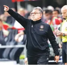  ?? AP PHOTO/JOHN BAZEMORE ?? Atlanta United FC coach Gerardo “Tata” Martino directs his players in an MLS playoff game against the New York Red Bulls on Nov. 25 in Atlanta. Martino will be celebrated for bringing instant MLS success to Atlanta. If he can add the MLS Cup championsh­ip in his final game as coach, his status as a legend will be difficult for his successor to match.