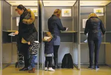  ?? Peter Dejong / Associated Press ?? Voters cast their ballots in the Dutch general election at a polling station in The Hague, Netherland­s.