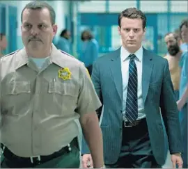  ?? Patrick Harbron Netf lix ?? JONATHAN GROFF, right, as FBI agent Holden Ford. Fellow crime buffs Charlize Theron and David Fincher are behind the scenes as executive producers.