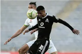  ??  ?? Four hands, one ball: Pirates goal scorer Vincent Pule uses his head to get the better of Raja Casablanca’s Marouane Hadhoudi at Orlando Stadium on Sunday. /Sydney Mahlangu/BackpagePi­x