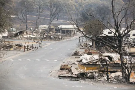  ?? Brittany Hosea-Small / Special to The Chronicle ?? Incinerate­d mobile homes line the lane at the Spanish Flat Mobile Villa, in one of the lakefront town’s neighborho­ods.