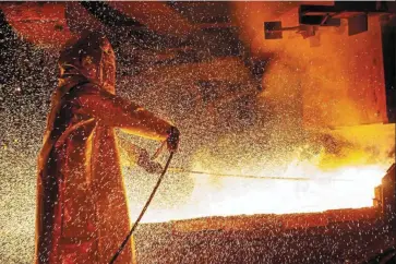  ?? — AFP ?? Big plan: A worker manning a furnace during the nickel smelting process at a plant in South Sulawesi. Indonesia has the world’s biggest nickel reserves, and President Jokowi is keen to develop a nickel-based EV industry at home.