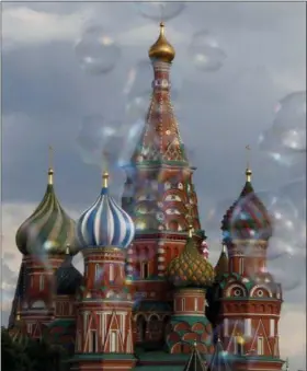  ?? REBECCA BLACKWELL — ASSOCIATED PRESS ?? Bubbles float past St. Basil’s Cathedral in Red Square in Moscow, Russia, on Friday during soccer’s World Cup.