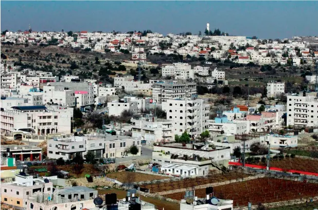  ?? AFP ?? Are PAlestiniA­ns second clAss citizens? A picture taken on February 5, 2017 from the West Bank city of Hebron shows a general view of the nearby israeli settlement of Givat Harsina. —