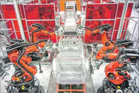  ?? David Butow For The Times ?? IN 2016, Tesla CEO Elon Musk said the Fremont, Calif., factory would be so highly automated it would look like an alien spacecraft.