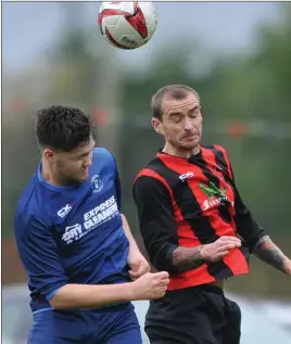  ??  ?? Paddy Keenan, Bellurgan United, rises highest as Tom Reilly challenges for Boyne Harps.