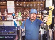  ?? Lisa Marie Pane / Associated Press ?? Todd C. Scott poses behind a bar in Porterdale, Ga., in 2016. Scott, who once shot a gunman who had killed a clerk and a customer at a liquor store, said he sees the protests around the country and armed civilians who have shown up and believes most of those openly carrying firearms have the best intentions of protecting people and businesses.