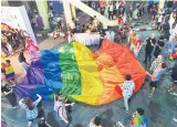  ??  ?? A large rainbow flag fills Le DTa’wan Plaza.