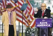  ?? Jacquelyn Martin Associated Press ?? JOHN EASTMAN, left, stands as former New York Mayor Rudy Giuliani speaks at a Donald Trump rally.