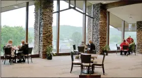  ?? (NWA Democrat-Gazette/Keith Bryant) ?? Diners enjoy lunch and a view while social distancing at BV’s Grill at the Country Club in Bella Vista. In order to keep diners at a safe distance, some tables have been moved into the Vista Room, in the center of the Country Club.