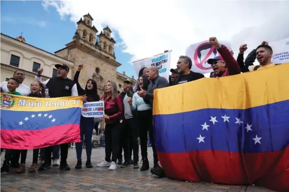  ?? ?? Venezuelan­s, who support opposition leader María Corina Machado, sing their native country’s national anthem during a protest demanding free and fair elections in Venezuela’s upcoming election, in Bolivar Square in Bogota, Colombia, April 6, 2024. (AP Photo/Fernando Vergara, File)